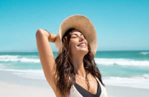 Beautiful,Girl,With,Straw,Hat,Enjoying,Sunbath,At,Beach.,Close